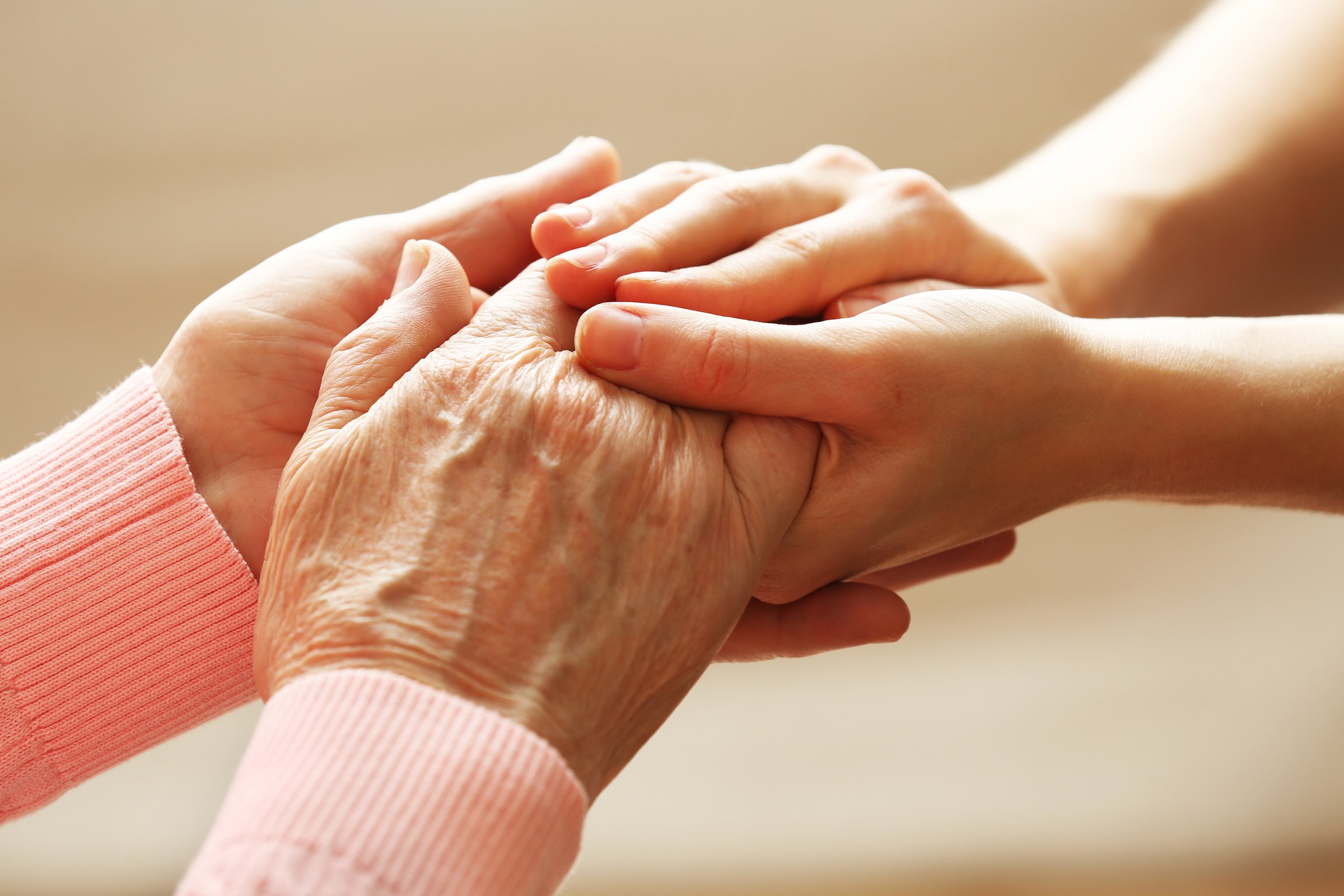 Young Person Holding an Elderly Woman's Hand